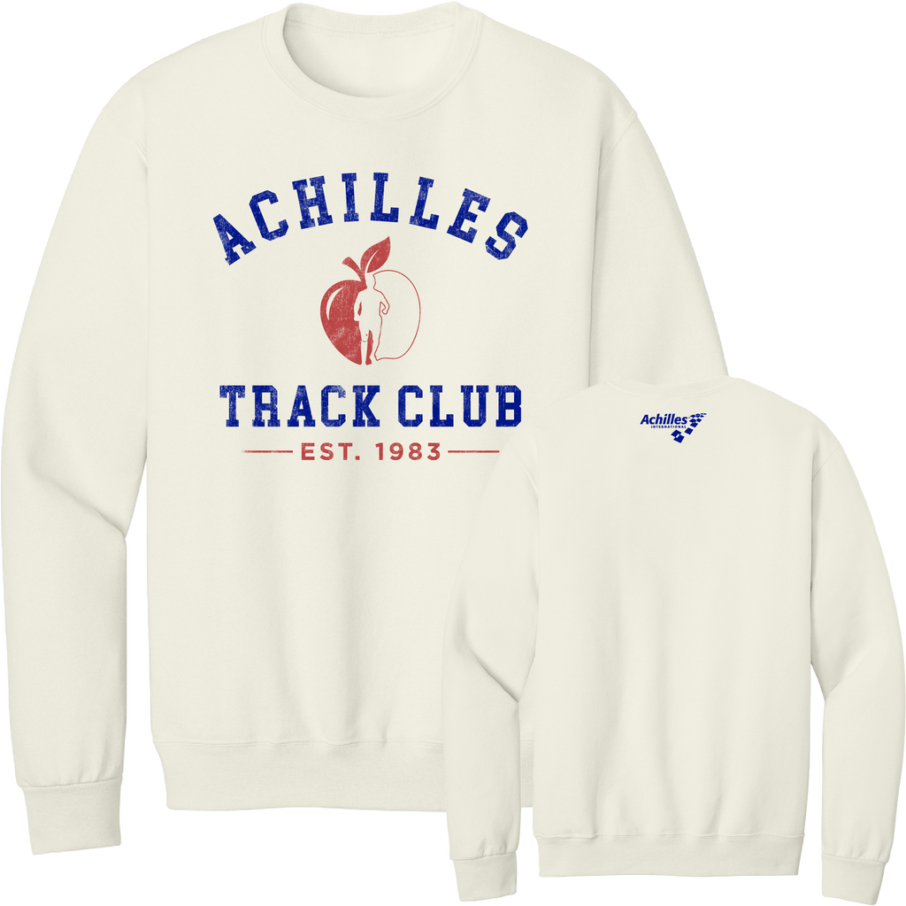 A cream crewneck sweatshirt shown from both front and back. The front features a blue graphic reading 'ACHILLES TRACK CLUB' with a red apple logo with a running silhouette in the center and 'EST. 1983' below 'track club'.